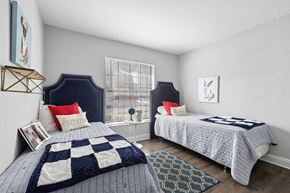 Tampa apartment for rent - A bedroom with two beds and a window.