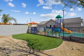 Las Vegas apartment for rent - A playground with a green slide and a mural on the wall.