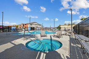 Las Vegas apartment for rent - A pool with a slide and sun loungers.