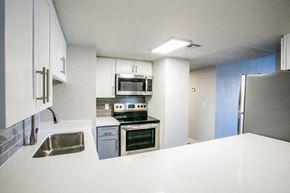 Las Vegas apartment for rent - a kitchen with a stove a sink and a refrigerator