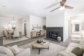 Winston Salem apartment for rent - Modern apartment living room with fireplace dining area and open floor plan at Sugar Creek Apartments Winston Salem