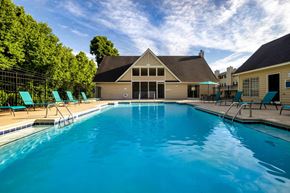 Winston Salem apartment for rent - Resort style swimming pool and clubhouse at Sugar Creek Apartments in Winston Salem NC with outdoor lounge seating
