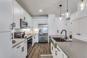 Grand Prairie apartment for rent - a large kitchen with white cabinets and stainless steel appliances