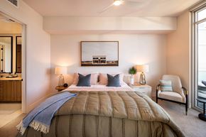 Frisco apartment for rent - A bedroom with a large bed and a chair.