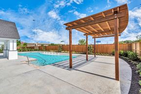 Houston townhouse for rent - a backyard with a pool and a pergola