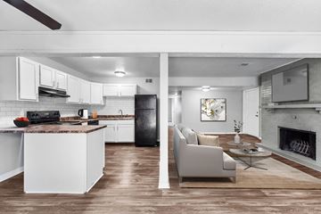 Overland Park apartment for rent - A modern kitchen with white cabinets and a black refrigerator.