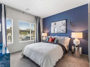 Las Vegas apartment for rent - A bedroom with a large bed and a blue lamp.