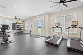 Hickory apartment for rent - A spacious gym with treadmills, elliptical machines, and a ceiling fan.