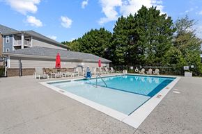 Hickory apartment for rent - Resort-style swimming pool in Hickory, NC at Hawks Landing with umbrellas and fenced lounge area