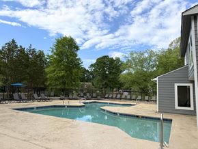 Greensboro apartment for rent - A pool surrounded by trees and chairs.