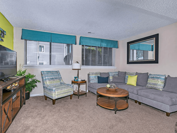 Wichita apartment for rent - a living room with couches and chairs and a tv