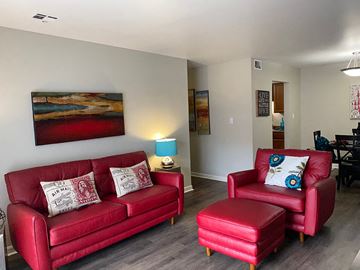 Evansville apartment for rent - a living room with a red couch and a chair