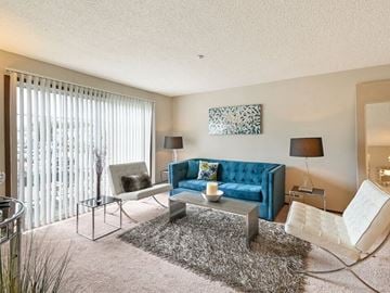 Fitchburg apartment for rent - a living room with a blue couch and a table