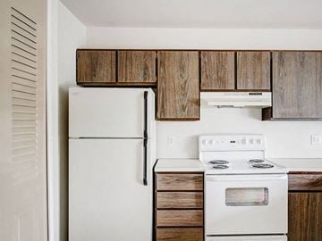 Norton Shores apartment for rent - a kitchen with a white stove and a refrigerator