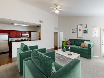 Lubbock apartment for rent - a living room with green couches and a table