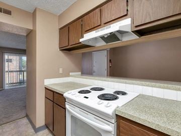 Wichita apartment for rent - a kitchen with a stove top oven and a microwave