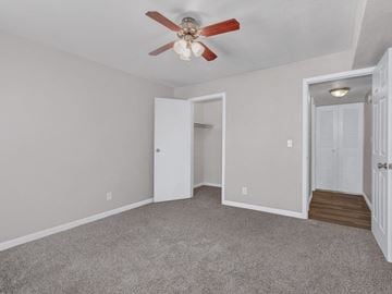 Wichita apartment for rent - a bedroom with a ceiling fan and a closet