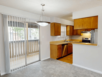 Baton Rouge apartment for rent - A kitchen with wooden cabinets and a dishwasher.