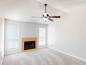 Baton Rouge apartment for rent - A room with a fireplace and a ceiling fan.