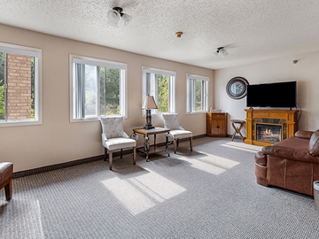 Rapid City apartment for rent - A living room with a fireplace and a television.