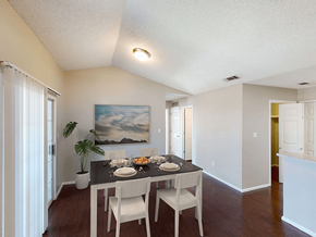 Lubbock apartment for rent - a dining room with a table and chairs and a painting on the wall