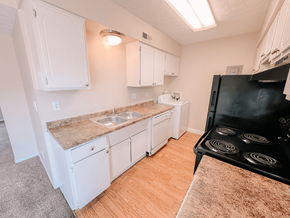 Reynoldsburg townhouse for rent - a kitchen with cabinets and a stove and a sink