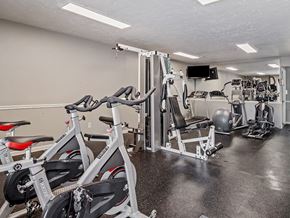 Howell apartment for rent - A gym with a row of stationary bikes and a variety of other equipment.