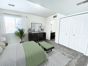 Grand Rapids townhouse for rent - a bedroom with a bed and a dresser and a mirror