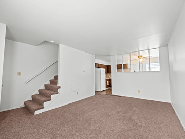 Columbus apartment for rent - a living room with carpet and a staircase