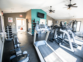 Wichita townhouse for rent - A gym with treadmills, weights, and exercise equipment.
