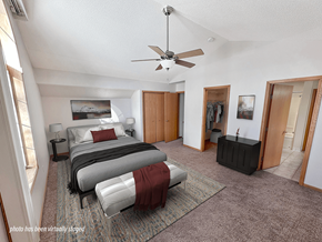 Rochester townhouse for rent - A bedroom with a bed, a dresser, and a ceiling fan.
