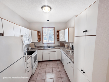 Rochester townhouse for rent - A kitchen with white cabinets and a tiled floor.