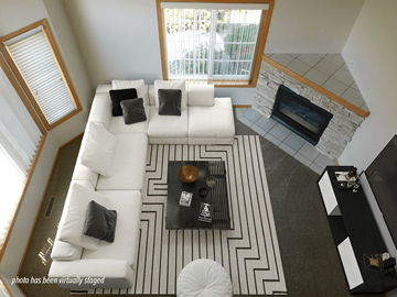 Rochester townhouse for rent - A living room with a white couch and a black and white rug.