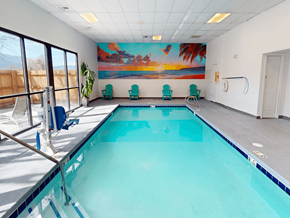 Canon City apartment for rent - A large indoor swimming pool with a mural on the wall.