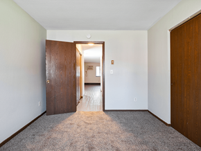 Toledo apartment for rent - a bedroom with a door to a hallway and a carpeted floor