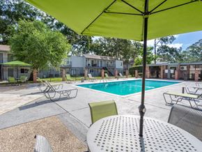Baton Rouge apartment for rent - seating by outdoor swimming pool
