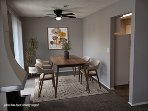 Omaha apartment for rent - A dining room with a table, chairs, and a ceiling fan.
