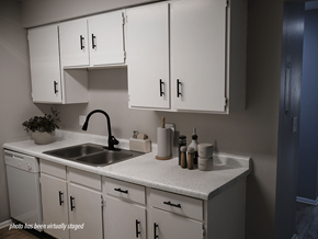 Omaha apartment for rent - A kitchen with white cabinets and a sink.