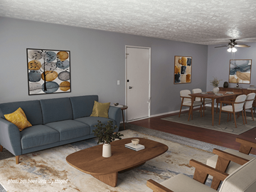 Omaha apartment for rent - A living room with a blue couch and a coffee table.
