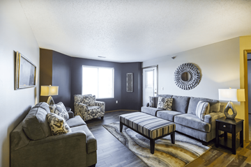 Bismarck apartment for rent - A living room with a grey couch and a wooden coffee table.
