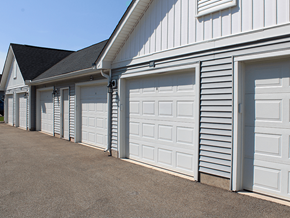 Ashland apartment for rent - A row of white garage doors in front of a white building.