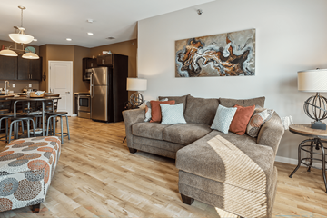 Jamestown apartment for rent - A living room with a grey couch and a wooden floor.