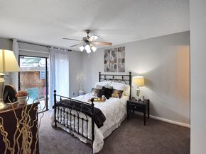 Little Rock apartment for rent - spacious bedroom with ceiling fan and large window