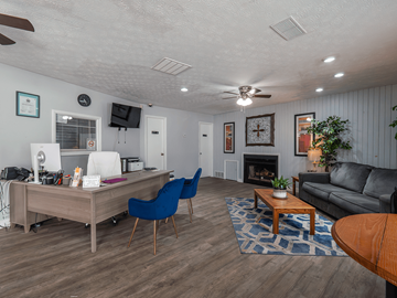 Chillicothe apartment for rent - a living room with a couch and a desk and a fireplace