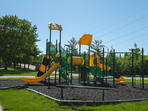 Kentwood apartment for rent - a playground with yellow and green equipment on a sunny day