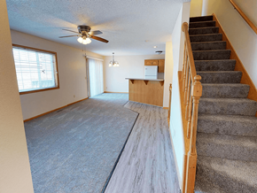 Rochester townhouse for rent - A room with a staircase and a ceiling fan.