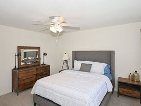 Wilmington apartment for rent - A bedroom with a bed, nightstand, and a dresser with a mirror.