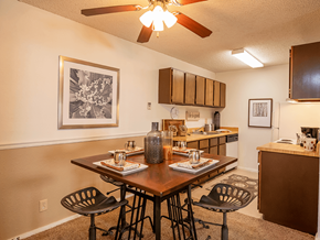 Wichita apartment for rent - a dining area with a table and chairs and a kitchen in the background