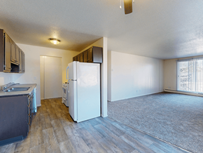 Brooklyn Park apartment for rent - A kitchen with a white refrigerator and wooden floors.
