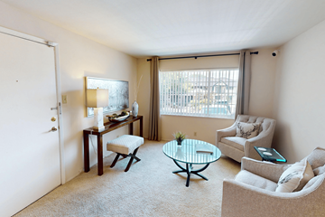 Affton townhouse for rent - A living room with a glass table and a chair.